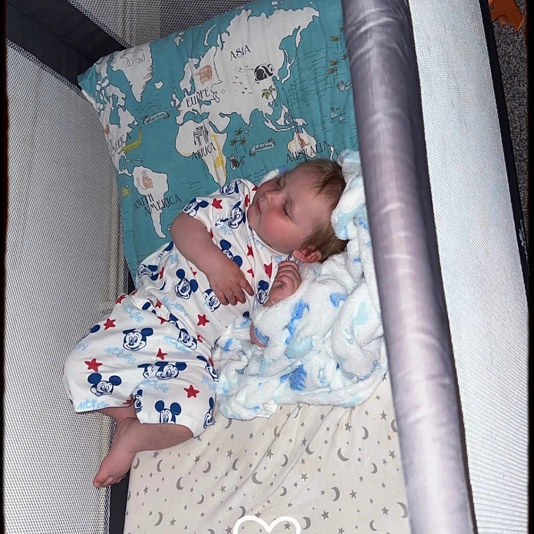 Elijah joined the competition — help win amazing prizes! baby, bed, bedroom, blanket, couch, cradle, crib, cushion, face, furniture, head, homedecor, indoors, infantbed, newborn, person, photography, portrait, quilt, sleeping