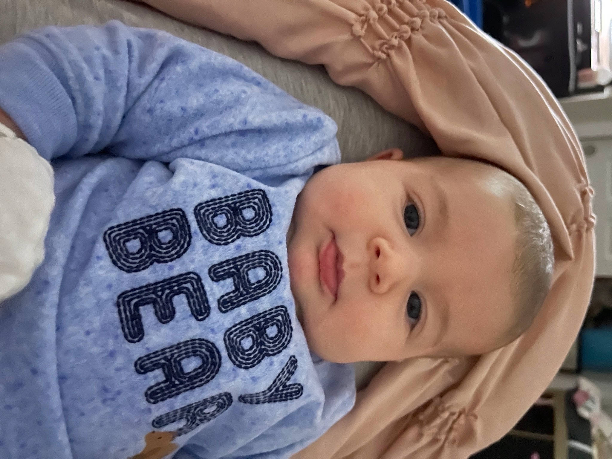 Hadleigh is registered to the contest to win money with this photo: baby, baby_toddler_clothing, cheek, child, chin, comfort, eye, eyebrow, eyelash, face, hat, head, human_body, linens, nose, person, product, skin, sleeve, smile