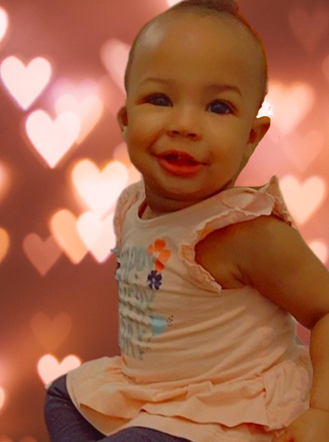 Camila joined the competition — help win amazing prizes! baby, baby_toddler_clothing, cheek, chin, eye, face, gesture, happy, head, human_body, iris, lip, mouth, nose, orange, person, pink, skin, sleeve, smile