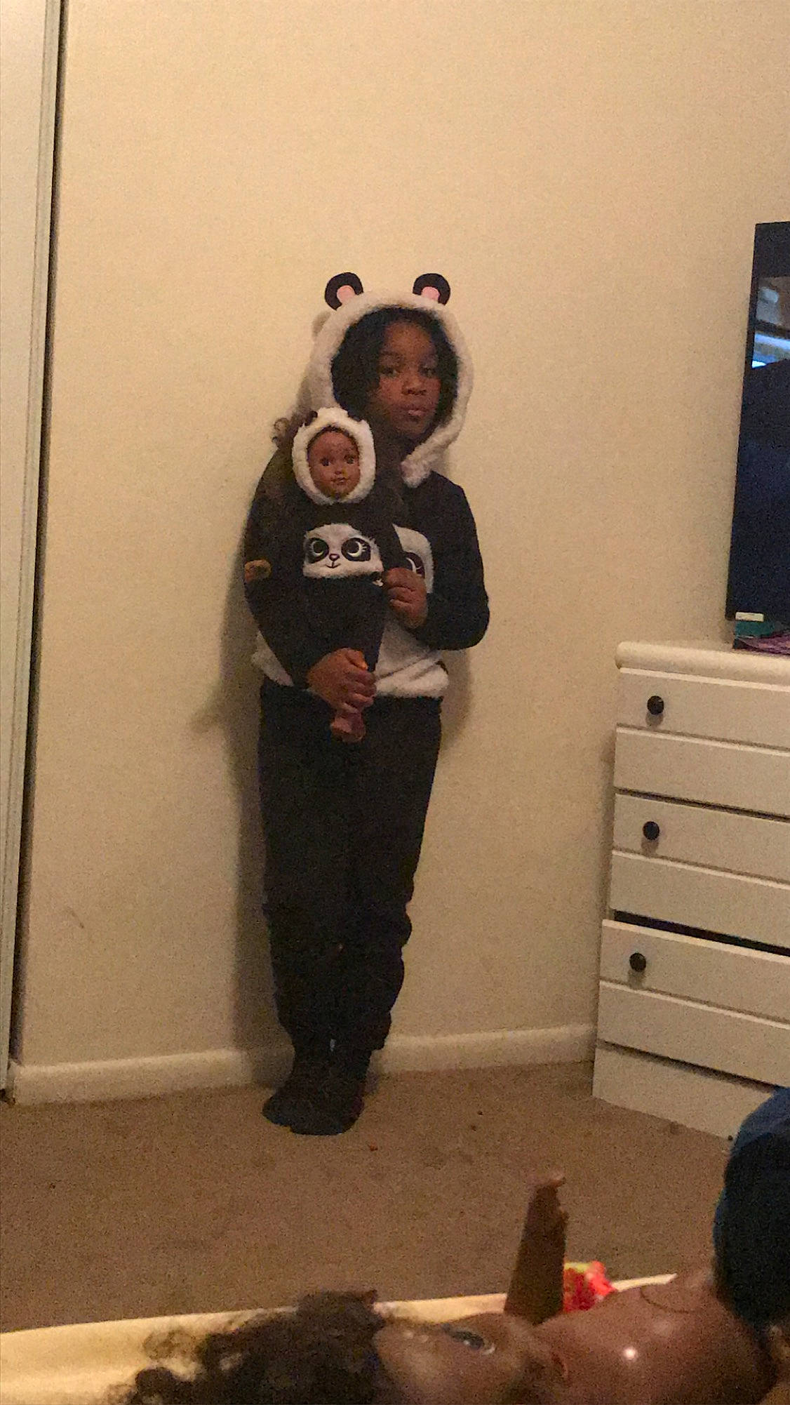 Kyrah is registered to the contest to win money with this photo: cabinetry, chest, chest_of_drawers, cupboard, drawer, dresser, event, floor, flooring, fun, happy, hardwood, knee, person, room, shoulder, standing, t_shirt, television, thigh