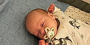 Cameron joined the competition — help win amazing prizes! baby, bed, blanket, child, clothing, comfort, cozy, cute, finger, hand, indoor, infant, knit, newborn, pacifier, penguin, person, resting, sleeping, soft