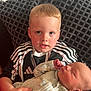Cameron is registered to the contest to win money with this photo: toddler, baby, child, infant, holding, couch, cushion, striped_clothing, sleeping, portrait, indoor, person, young_child, cozy, family, newborn, cute, face, hands, resting