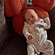 Cameron joined the competition — help win amazing prizes! baby, child, comfort, couch, cozy, face, furniture, head, home, indoor, infant, onesie, orange_pillow, pillow, portrait, relaxing, resting, soft_texture, white_clothing, young