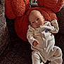 baby, child, comfort, couch, cozy, face, furniture, head, home, indoor, infant, onesie, orange_pillow, pillow, portrait, relaxing, resting, soft_texture, white_clothing, young