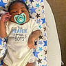 Ravi joined the competition — help win amazing prizes! baby, infant, child, sleeping, pacifier, onesie, star_pattern, blanket, baby_bouncer, portrait, face, hand, arms, legs, indoor, cozy, lying_down, newborn, text_on_clothing, photograph