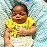 Ravi is registered to the contest to win money with this photo: newborn, baby, sleeping, infant, portrait, yellow_outfit, blue_blanket, pacifier, indoors, lying_down, peaceful, cozy, baby_clothing, white_pants, facial_features, closed_eyes, dark_hair, soft_blanket, nursery, photography