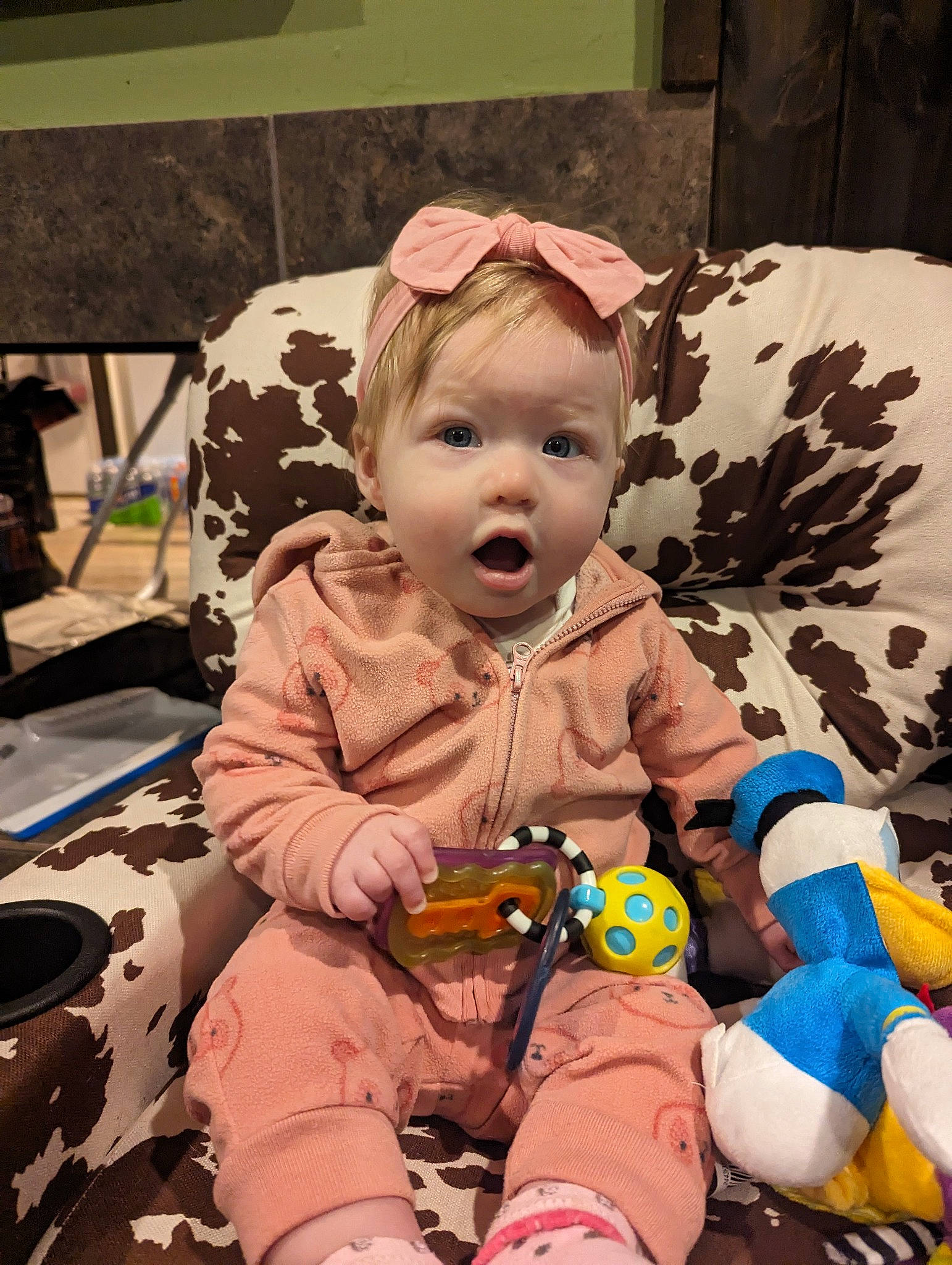 Remi is registered to the contest to win money with this photo: baby, baby_toddler_clothing, cheek, child, costume, event, fun, fur, happy, holiday, lap, people, person, pink, room, sitting, skin, stuffed_toy, surprise, teddy_bear