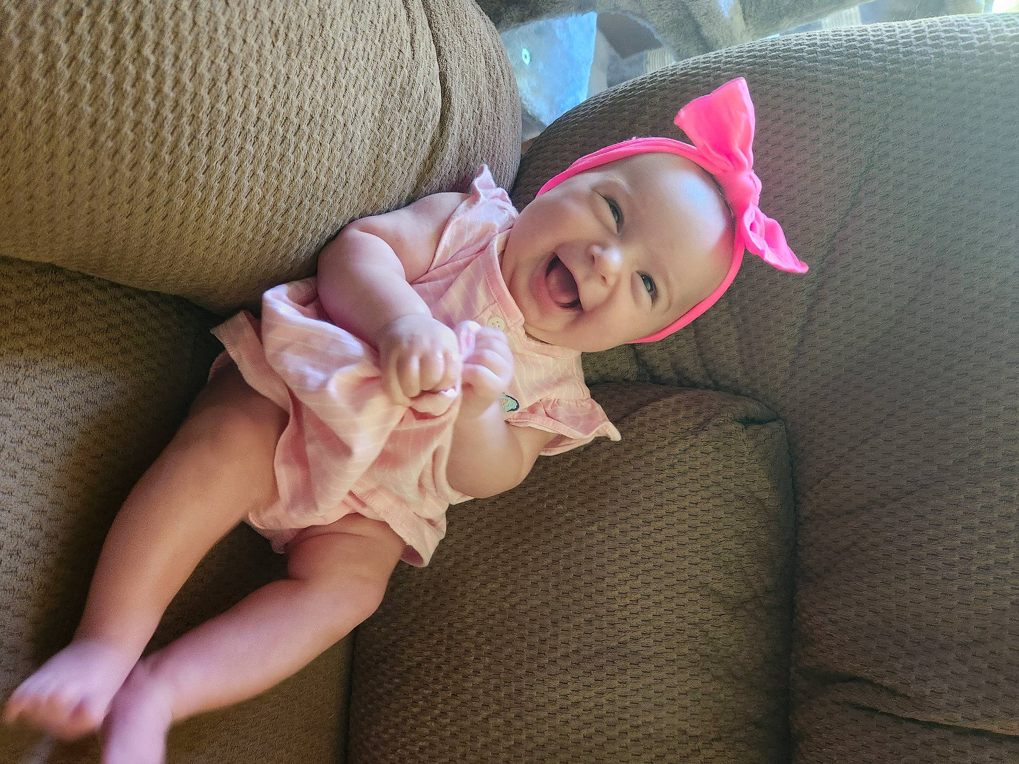 Raina is registered to the contest to win money with this photo: baby, baby_toddler_clothing, blond, comfort, eye, finger, foot, hat, head, human_leg, leg, linens, lip, person, pink, skin, sleeve, smile, sun_hat, thigh