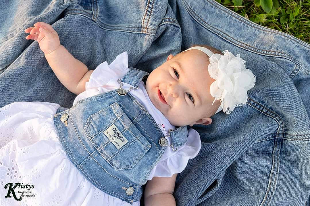 Raina is registered to the contest to win money with this photo: baby, baby_toddler_clothing, blue, clothing, comfort, denim, dress_shirt, eye, face, gesture, hand, head, headwear, human_body, jeans, leg, person, plant, skin, sleeve