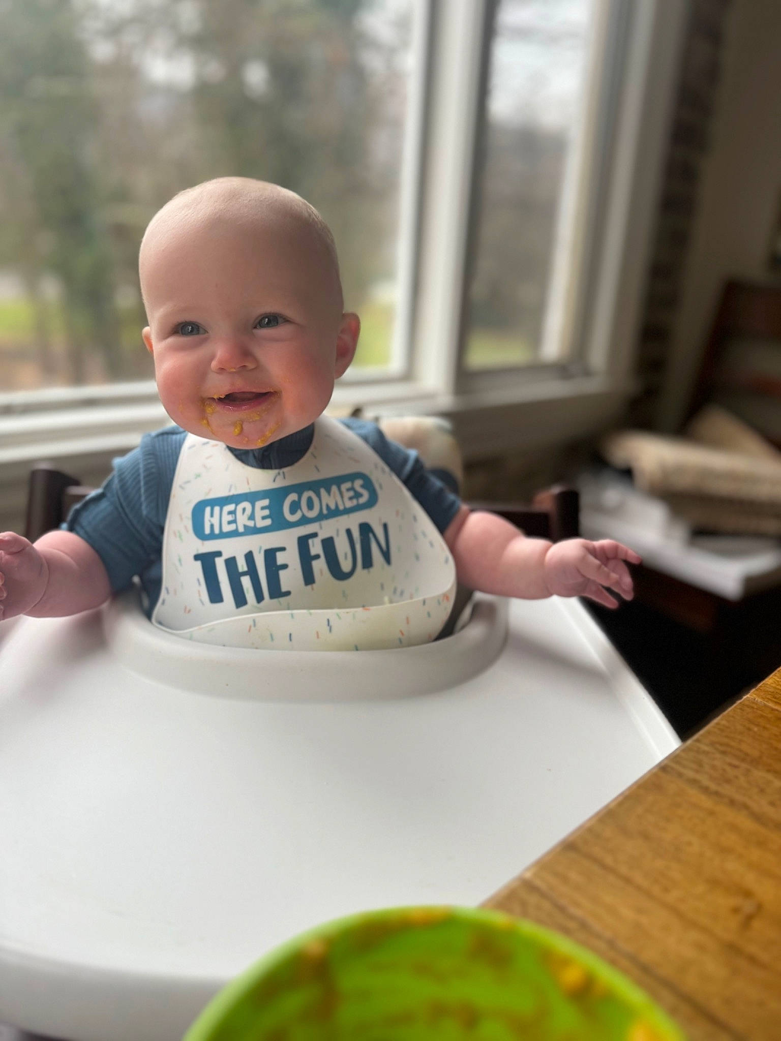 Dylan joined the competition — help win amazing prizes! baby, baby_food, baby_products, baby_toddler_clothing, bib, cheek, child, desk, eye, food, happy, joy, logo, person, plant, sitting, skin, sleeve, smile, t_shirt
