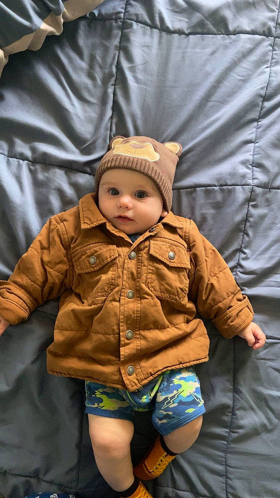 Toby James Brigg joined the competition — help win amazing prizes! baby, baby_toddler_clothing, cap, child, comfort, cool, eye, face, grass, happy, headwear, jacket, knit_cap, outerwear, person, sitting, skin, sleeve, thigh, toddler