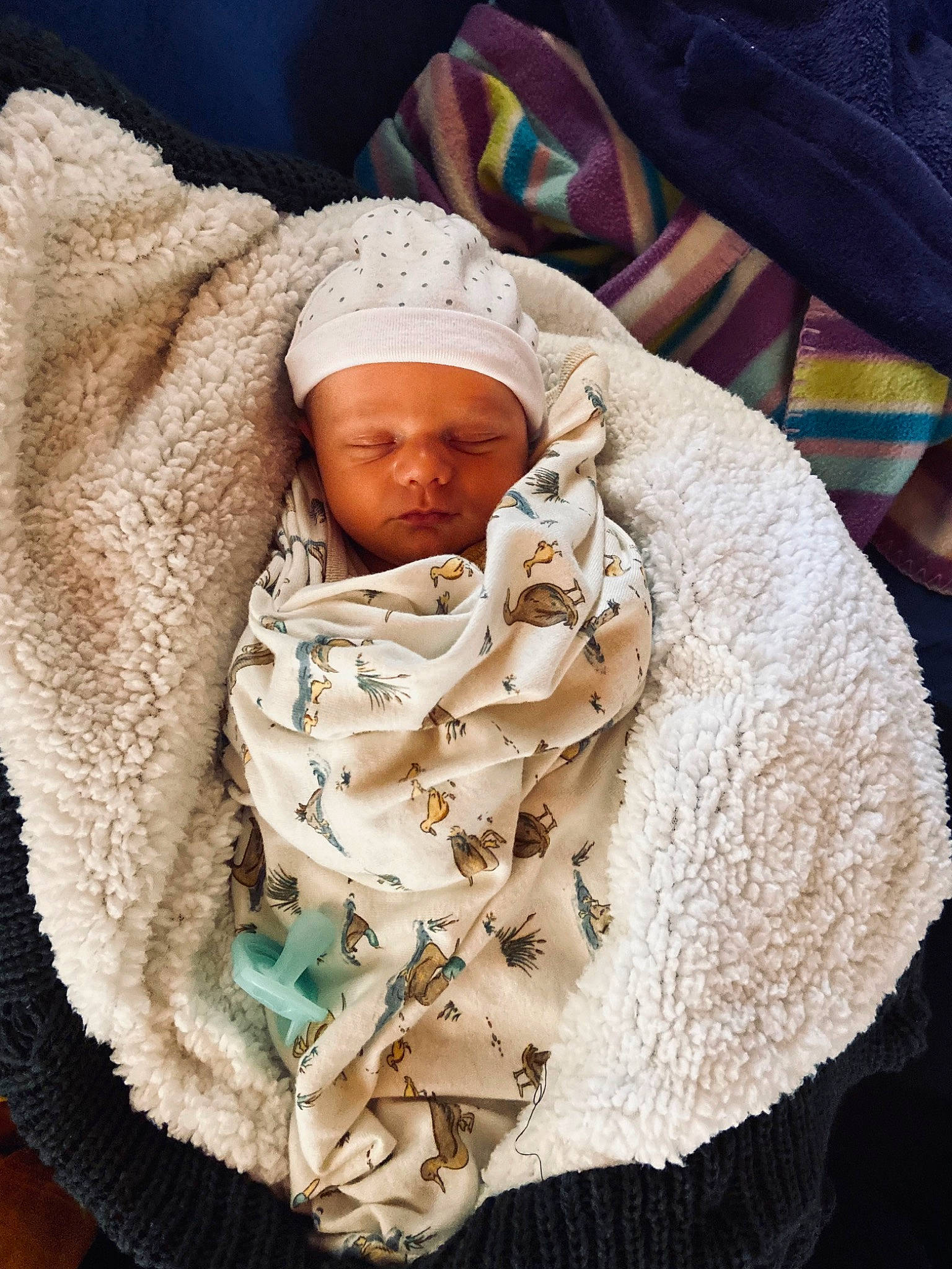 Toby James Brigg is registered to the contest to win money with this photo: baby, baby_sleeping, baby_toddler_clothing, blanket, child, comfort, fur, hat, headwear, knit_cap, linens, person, room, scarf, sleeve, textile, thumb, toddler, wool