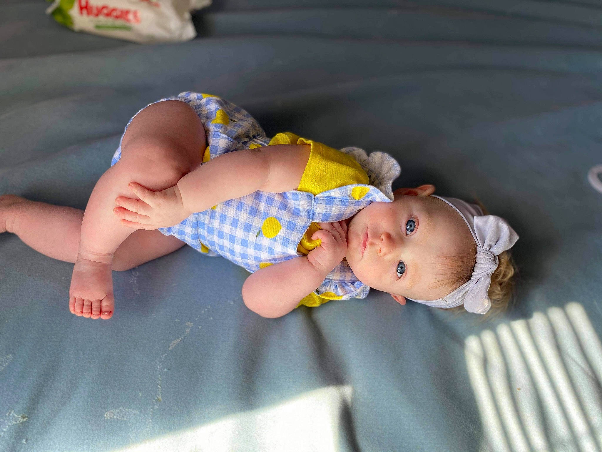 Saffire is registered to the contest to win money with this photo: baby, baby_toddler_clothing, barefoot, child, comfort, finger, fun, grass, hand, headgear, human_body, leg, mammal, pattern, person, skin, sleeve, sock, thigh, toddler