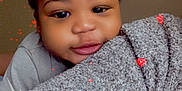 Mavrik joined the competition — help win amazing prizes! baby, child, face, blanket, hearts, smile, portrait, indoors, cute, cozy, fuzzy, closeup, happy, young, infant, soft, black_hair, warm, expression, love