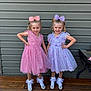 child, girl, dress, pink, purple, bow, shoes, socks, smile, posing, outdoor, wooden_deck, wall, happy, fashion, tulle, ribbon, pearls, twins, cute