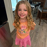 Avalinaandandilyn is registered to the contest to win money with this photo: child, girl, smiling, blonde_hair, curly_hair, tshirt, skirt, barefoot, indoor, kitchen, floor, wooden_floor, furniture, chair, table, happy, portrait, standing, person, casual_clothing