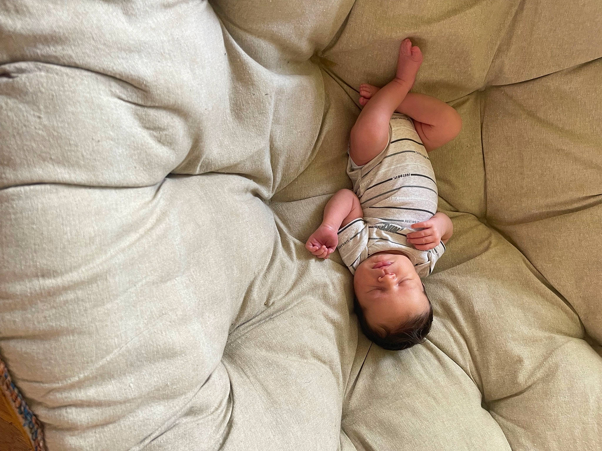 Parker is registered to the contest to win money with this photo: arm, baby, baby_products, baby_sleeping, baby_toddler_clothing, child, comfort, finger, foot, gesture, hand, human_body, human_leg, leg, linens, nail, person, skin, sleeve, thumb