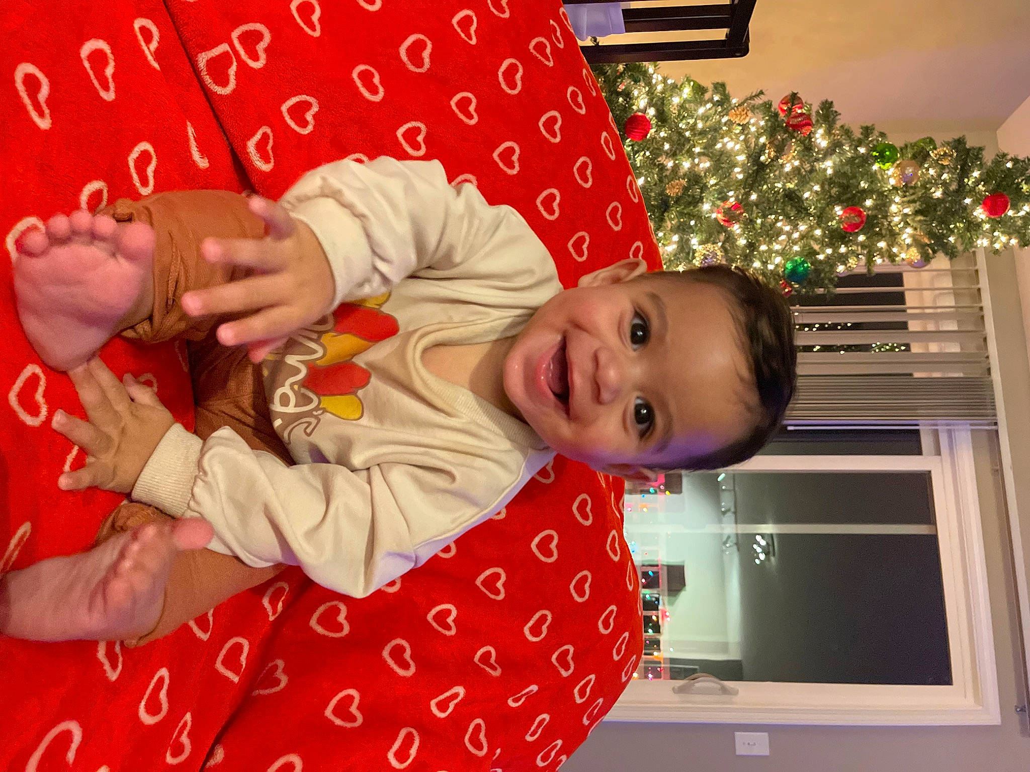 Deandre joined the competition — help win amazing prizes! baby, baby_toddler_clothing, child, christmas, christmas_eve, event, facial_expression, fun, gesture, happy, head, holiday, joy, nail, pattern, person, red, room, sleeve, smile