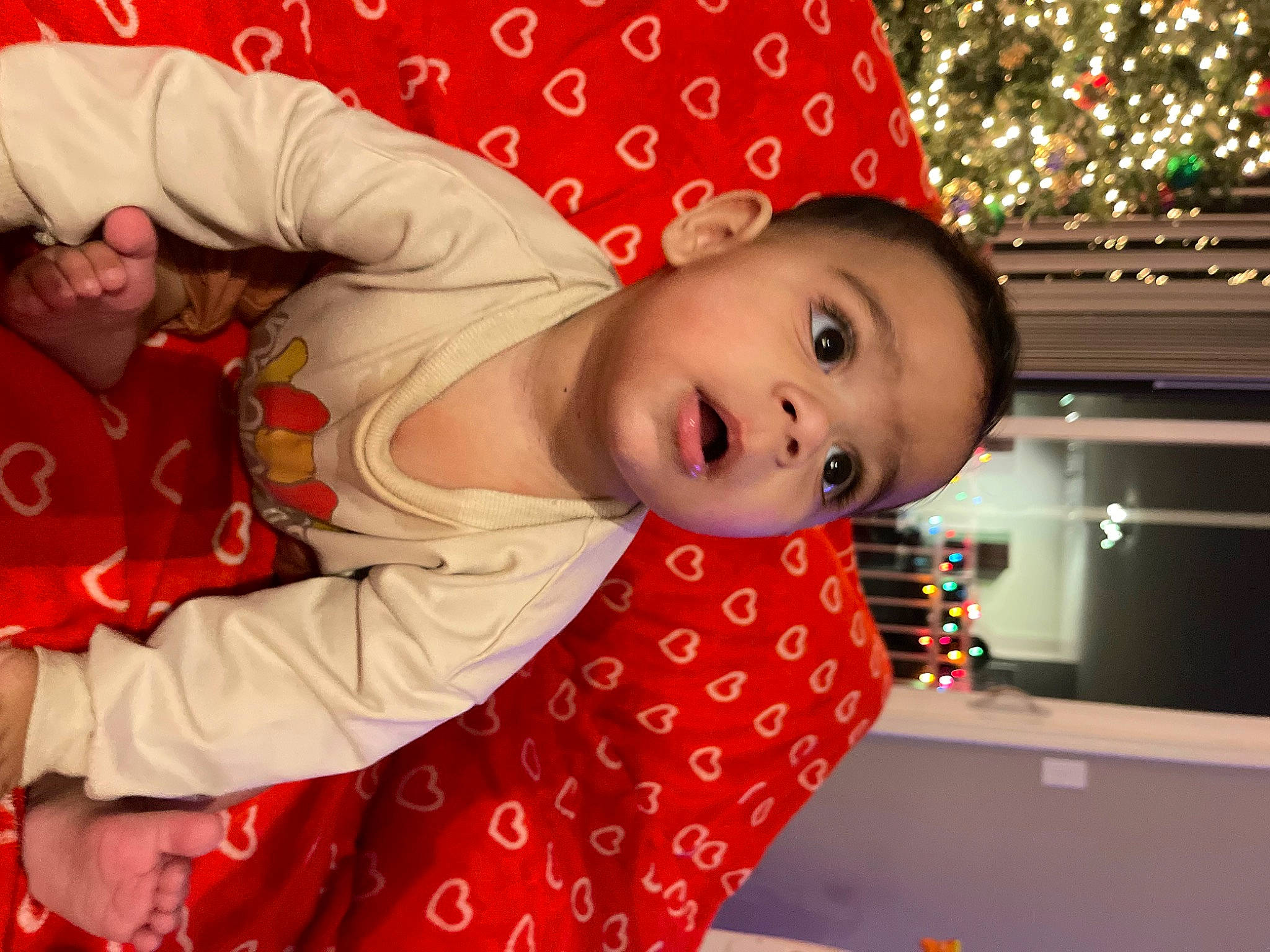 Deandre is registered to the contest to win money with this photo: baby, baby_toddler_clothing, child, christmas, christmas_eve, event, fun, happy, holiday, leisure, pattern, person, product, room, sitting, sleeve, surprise, toddler