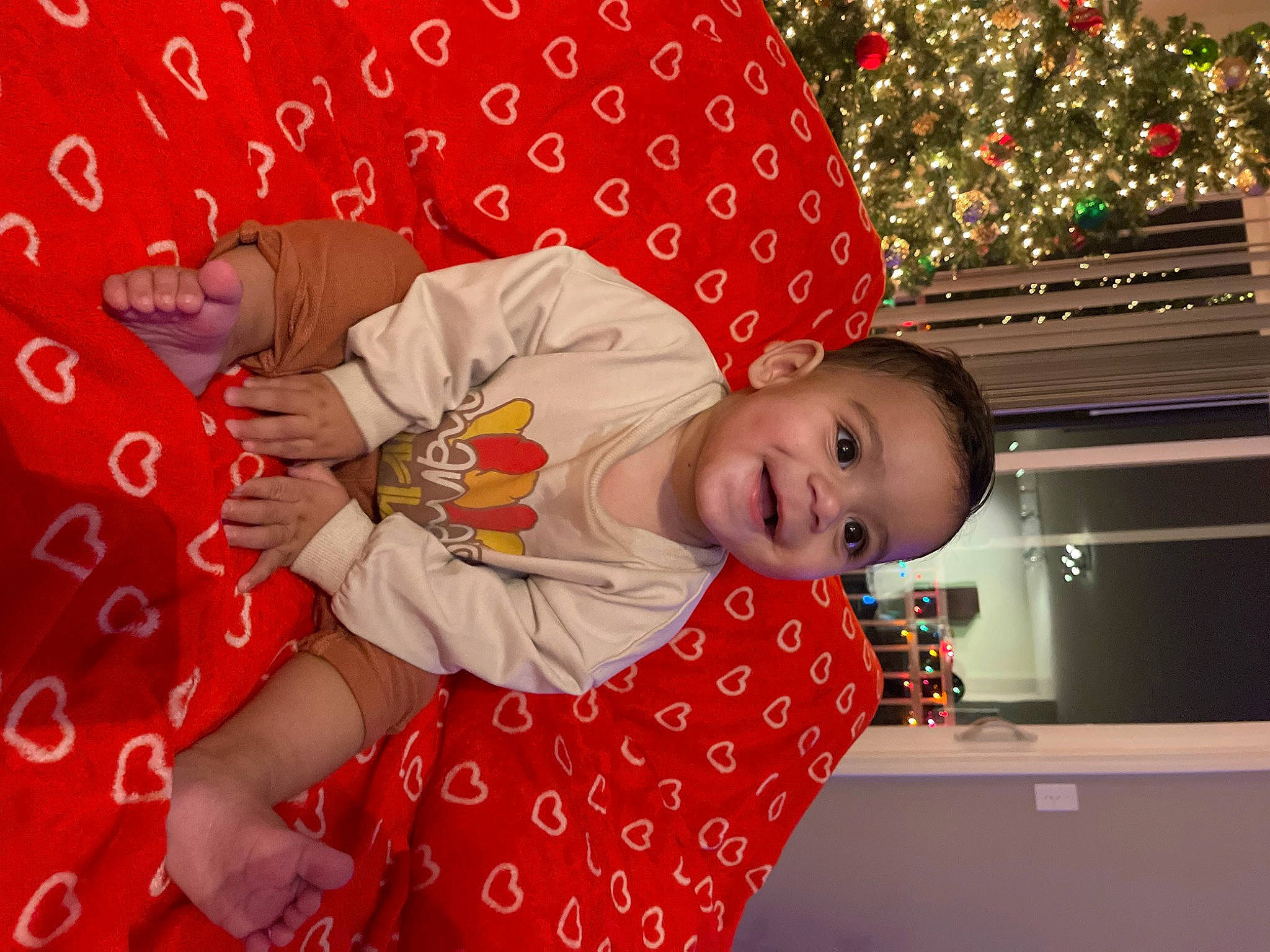 Deandre joined the competition — help win amazing prizes! baby, baby_toddler_clothing, child, christmas_eve, christmas_tree, comfort, event, facial_expression, fun, happy, head, holiday, leisure, linens, pattern, person, red, room, sleeve, smile