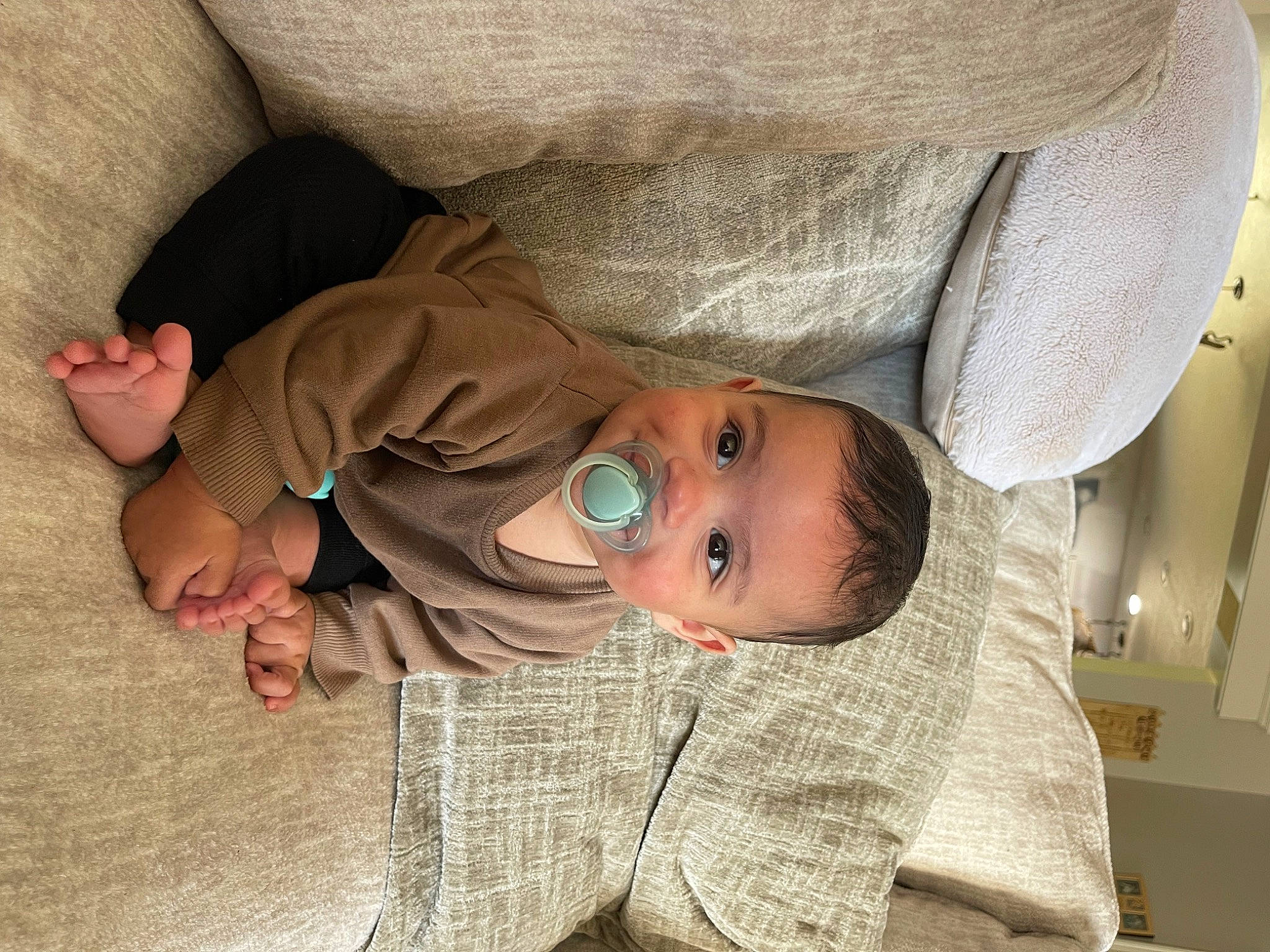 Deandre is registered to the contest to win money with this photo: baby, baby_products, baby_toddler_clothing, cheek, child, chin, comfort, foot, gesture, headgear, human_body, linens, mouth, nose, person, skin, sleeve, smile, textile, toddler