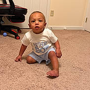 Sutton joined the competition — help win amazing prizes! baby, birthday_boy, child, toddler, crawling, carpet, indoor, gaming_chair, blue_ball, white_ball, shorts, tshirt, person, floor, room, door, wall_outlet, curious, barefoot, home