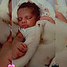 baby, sleeping, blanket, infant, curly_hair, peaceful, cozy, closeup, soft_texture, indoors, heart_emoji, blue_hearts, pink_hearts, black_hearts, wrapped, cute, resting, child, portrait, adorable