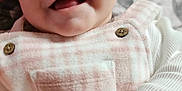 Olivia is registered to the contest to win money with this photo: baby, smiling, closeup, face, infant, cute, happy, apparel, pink, white, clothing, button, child, portrait, skin, young, cute_expression, soft_texture, fabric, sleeve