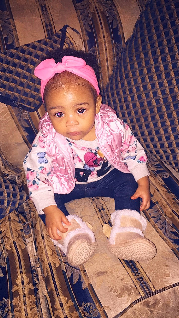 Aviyanna is registered to the contest to win money with this photo: child, eye, fun, girl, hair_accessory, headgear, infant, person, pink, product, sitting, skin, smile, textile, toddler