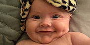 Koa joined the competition — help win amazing prizes! baby, smile, cheeks, towel, leopard_print, headwear, bed, pillow, skin, infant, cute, portrait, lying_down, happy, indoors, child, face, closeup, naked_torso, expression