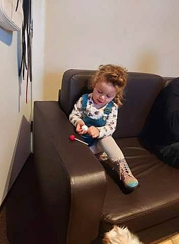 Antonia joined the competition — help win amazing prizes! baby, blond, comfort, couch, floor, flooring, home, human_body, lap, living_room, person, play, room, shoulder, sitting, snapshot, sock, sofa_bed, studio_couch, toddler