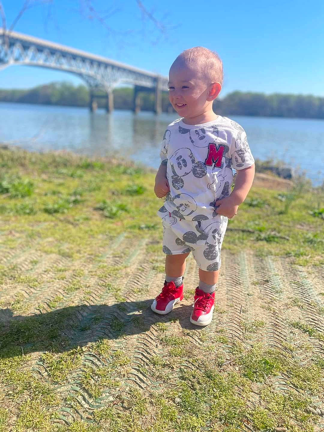 Xzavier is registered to the contest to win money with this photo: child, fun, grass, grassland, happy, horizon, joy, lake, landscape, leisure, people_in_nature, person, plant, prairie, recreation, reservoir, sky, soil, t_shirt, toddler