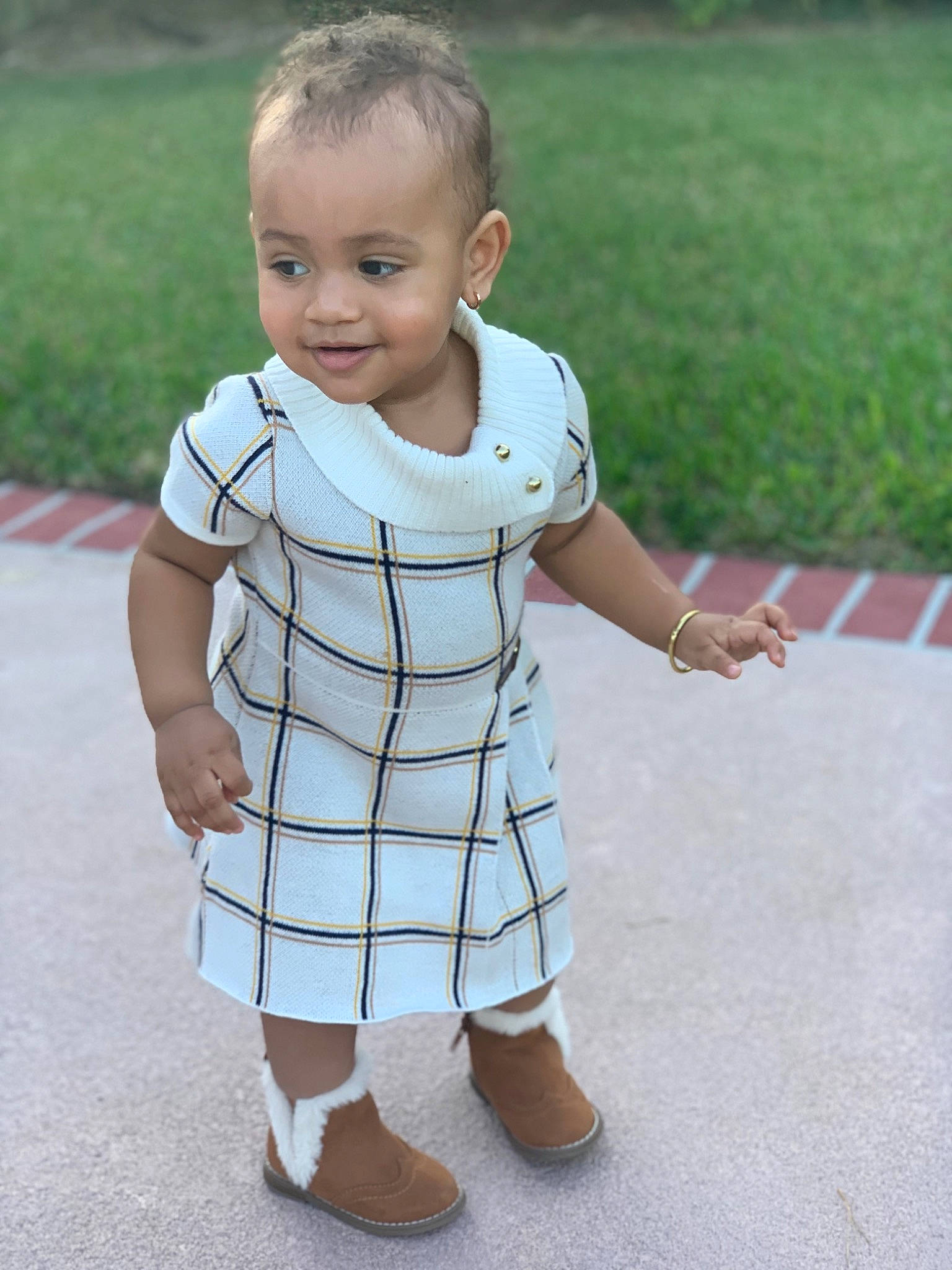 Cali is registered to the contest to win money with this photo: baby, baby_toddler_clothing, child, clothing, design, dress, footwear, joint, knee, leg, pattern, person, plaid, play, shoe, skin, sleeve, standing, toddler, walking