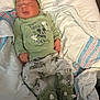 Luca joined the competition — help win amazing prizes! newborn, baby, sleeping, infant, green_hat, green_shirt, mickey_mouse, blanket, white_blanket, striped_blanket, dinosaur_slippers, cozy, cute, soft, lying_down, child, pajamas, indoors, peaceful, portrait