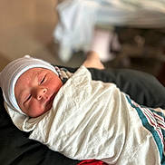Luca joined the competition — help win amazing prizes! newborn, baby, swaddled, hat, sleeping, infant, soft_focus, blanket, striped, closeup, person, cute, resting, indoors, headwear, portrait, wrapped, comfort, new_life, tender_moment