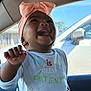 Azira is registered to the contest to win money with this photo: baby, infant, child, smiling, headwrap, bow, bib, earrings, hand, car_interior, car_window, seat, sunlight, portrait, happy, cute, holding, window_reflection, facial_expression, teeth