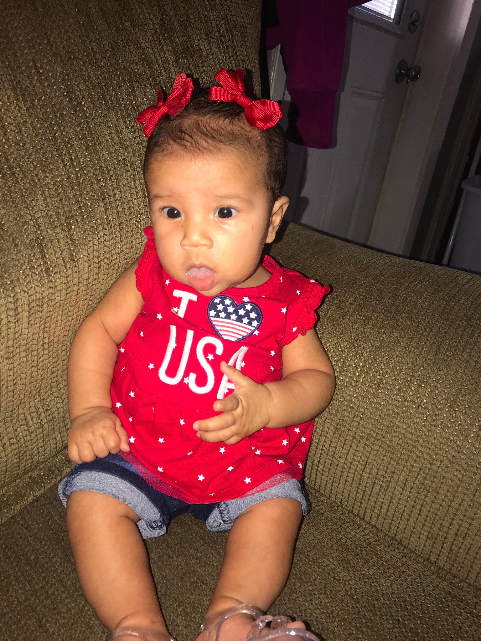 Melani is registered to the contest to win money with this photo: baby, baby_toddler_clothing, cheek, child, eye, fun, hair_accessory, headgear, iris, leg, lip, mouth, neck, pattern, person, pink, sitting, skin, standing, thigh