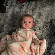 Serenity joined the competition — help win amazing prizes! baby, child, infant, portrait, lying_down, blanket, pink, gray, plaid, fluffy, bed, indoors, sneakers, shoes, clothing, wide_eyes, looking_at_camera, cozy, cute, photography