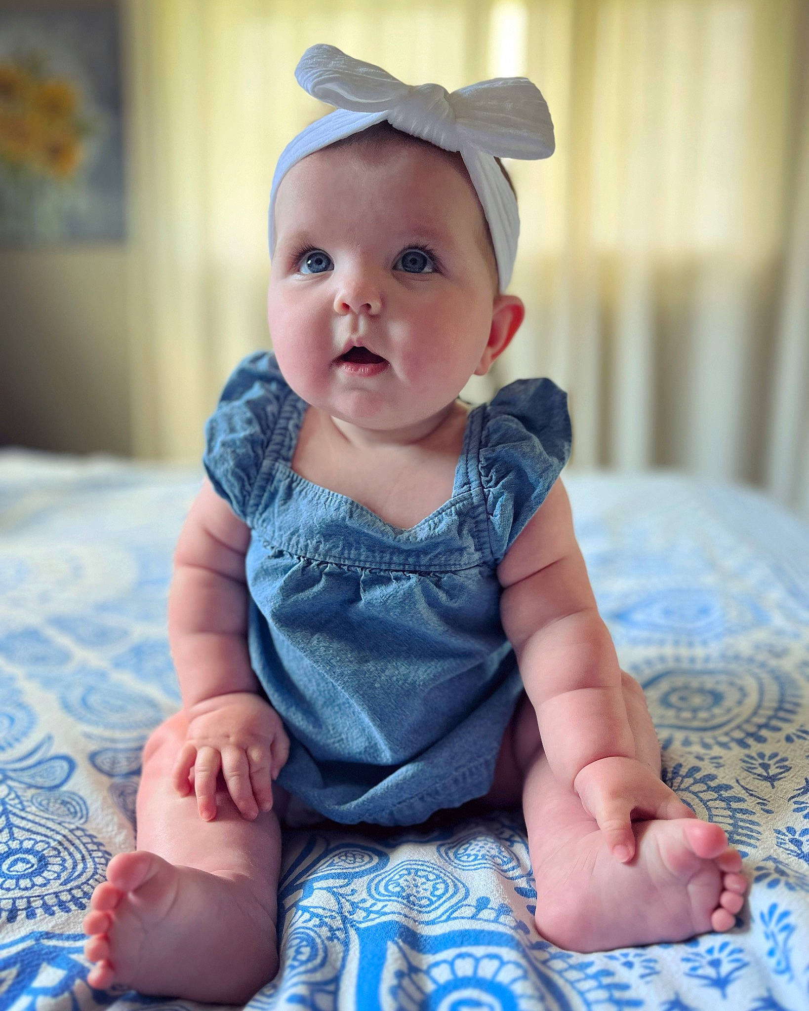 Vivi joined the competition — help win amazing prizes! baby, baby_toddler_clothing, blue, cheek, clothing, collar, dress, electric_blue, embellishment, eye, face, happy, hat, head, iris, pattern, person, sitting, skin, sleeve