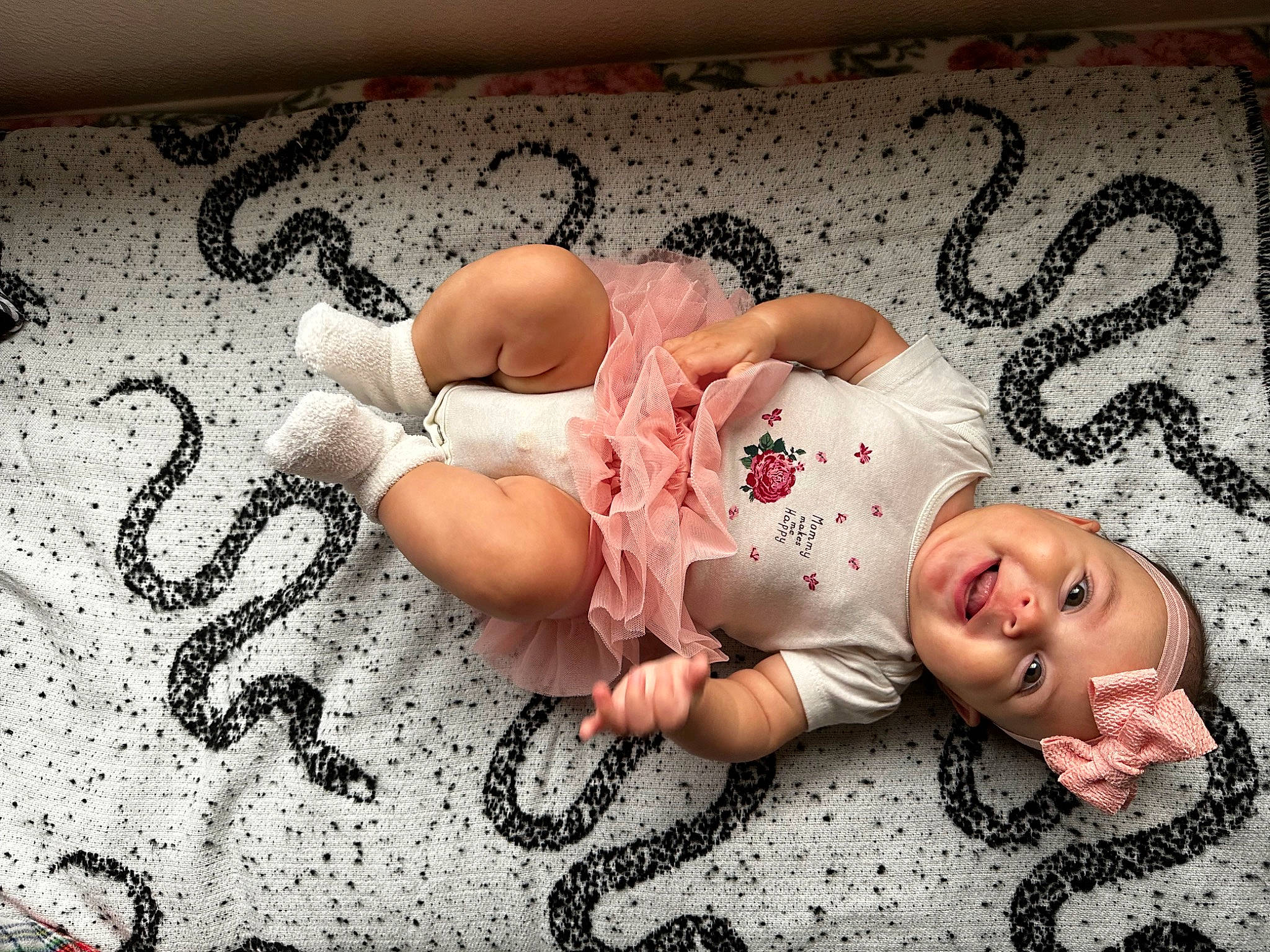 Athena joined the competition — help win amazing prizes! baby, baby_toddler_clothing, bed, bedding, child, comfort, flash_photography, flesh, floor, flooring, headwear, human_leg, linens, pattern, person, room, skin, smile, textile, thigh