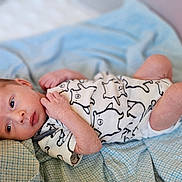 Daimion joined the competition — help win amazing prizes! baby, bed, blanket, cat_print, child, curious, cute, hand, head, indoors, infant, lying_down, newborn, onesie, peaceful, portrait, skin, sleeping_area, small, soft