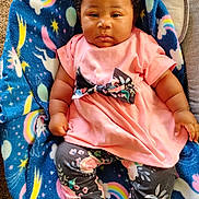 Amelia joined the competition — help win amazing prizes! baby, infant, child, blanket, blue_blanket, rainbow, unicorn, stars, pink_dress, bow, floral_pattern, leggings, carpet, curly_hair, sitting, indoors, cute, portrait, person, comfortable