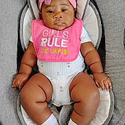 Amelia joined the competition — help win amazing prizes! baby, bib, car_seat, child, chubby_legs, clothing, comfortable, cushion, cute, flower, indoor, infant, person, pink_headband, portrait, seat, serious_expression, skin, socks, young_child