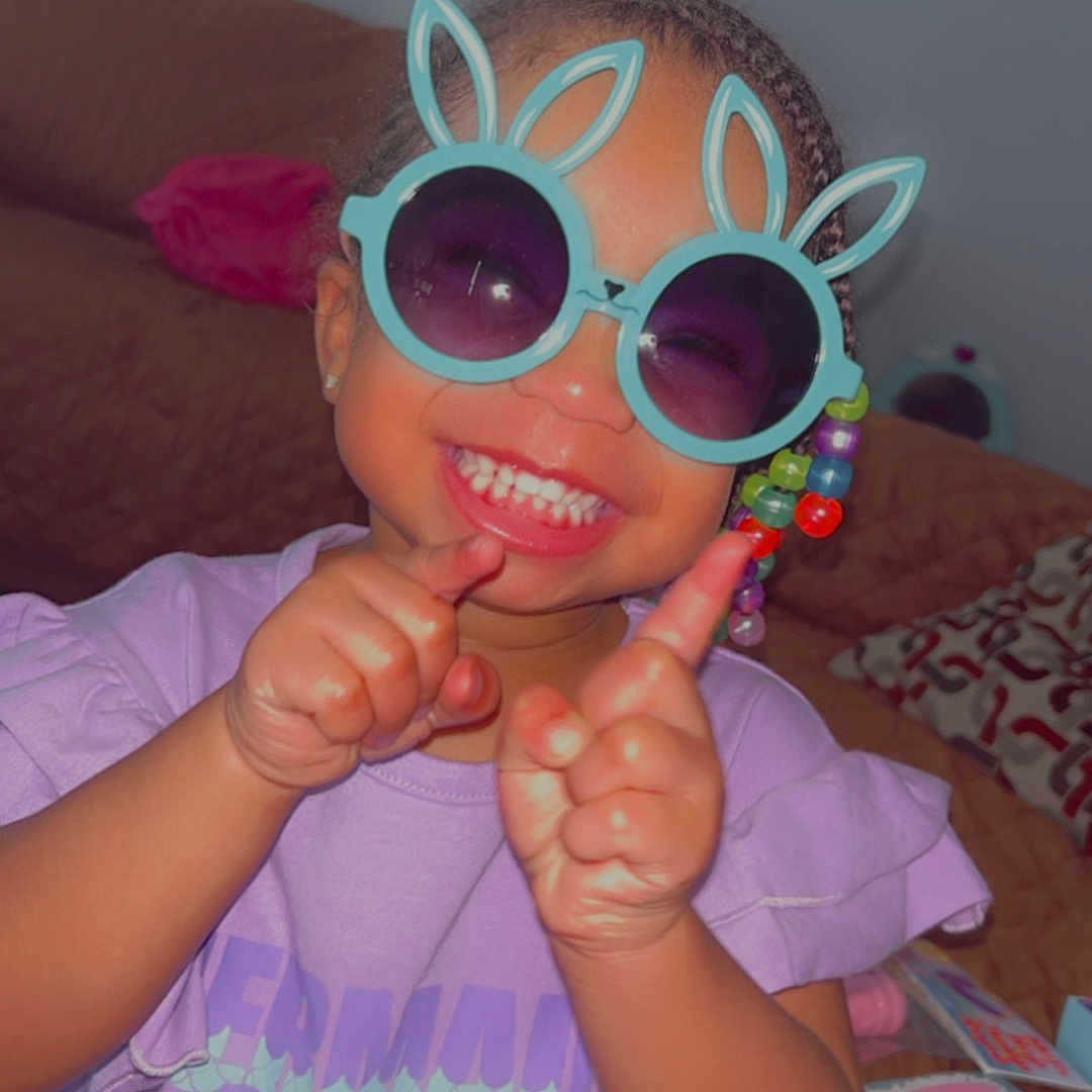 Nayeli joined the competition — help win amazing prizes! accessories, baby, bodypart, clothing, face, finger, food, furniture, glasses, hand, happy, head, mouth, person, photography, portrait, smile, sunglasses, sweets, t_shirt