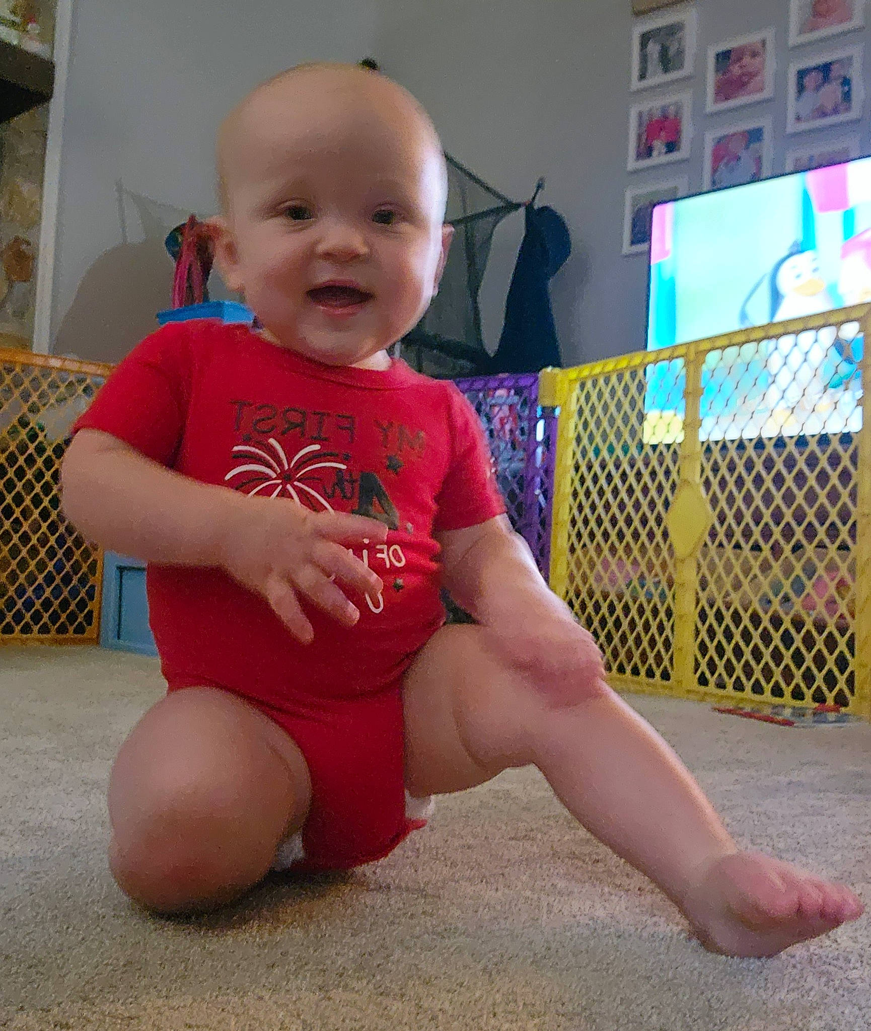 Brandon is registered to the contest to win money with this photo: baby, baby_toddler_clothing, finger, floor, flooring, happy, human_leg, joint, knee, leg, person, pink, shoulder, skin, sleeve, smile, t_shirt, thigh, thumb, toddler
