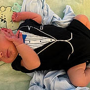 Everett joined the competition — help win amazing prizes! newborn, baby, sleeping, portrait, infant, tuxedo, onesie, blanket, bed, pacifier, hands, feet, curled_up, peaceful, indoors, cozy, soft, resting, child, close_up