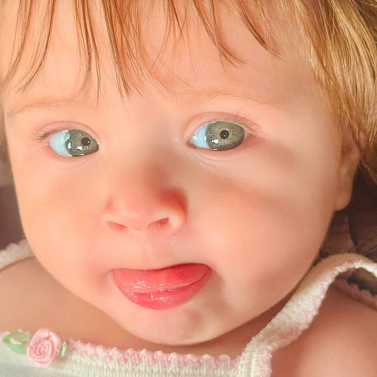 Leilany joined the competition — help win amazing prizes! baby, child, infant, portrait, close_up, face, eyes, blue_eyes, blonde_hair, tongue_out, adorable, looking_at_camera, expression, smiling, indoor, photography, headshot, clothing, pastel, cute
