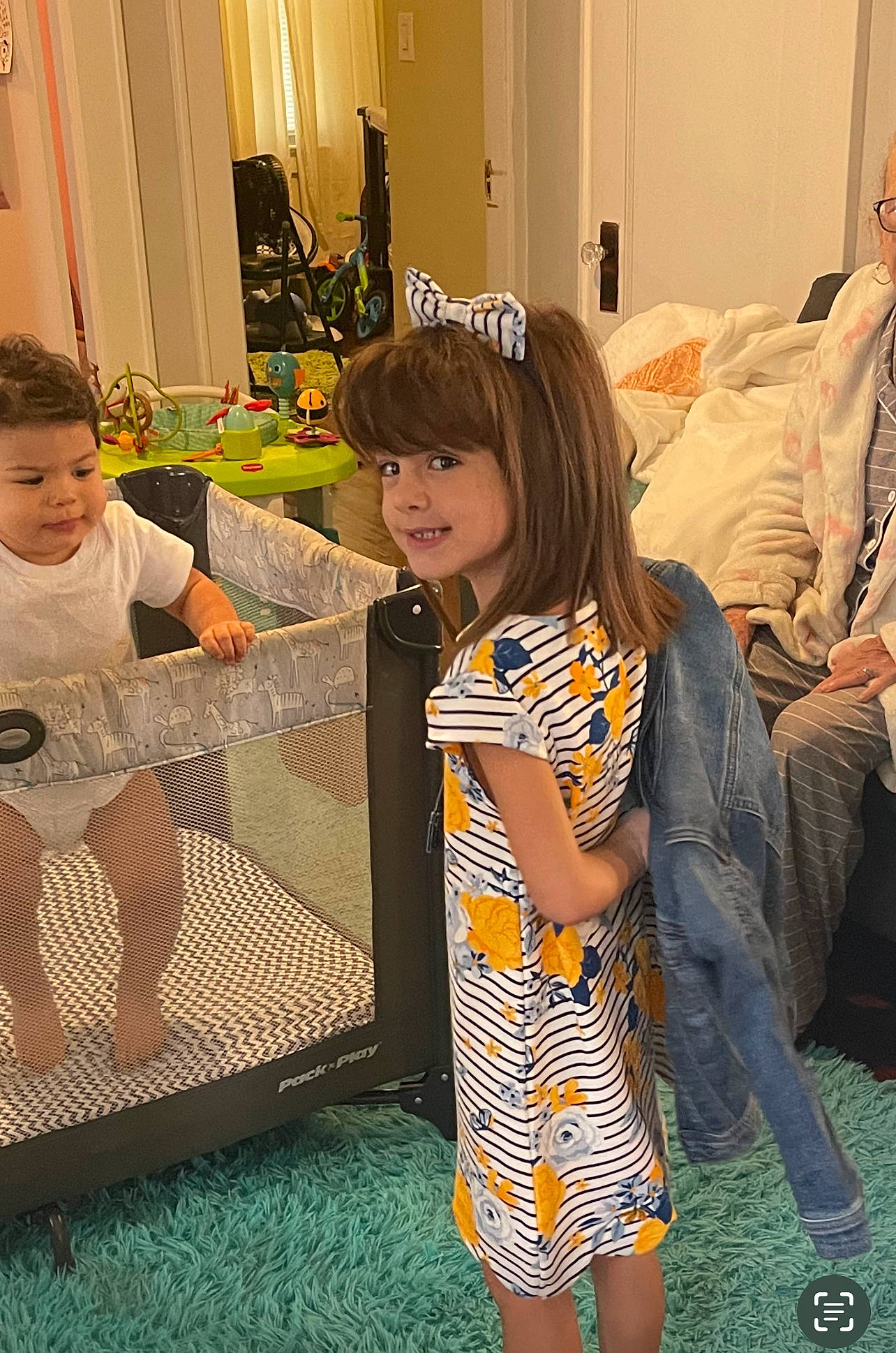 Angelica is registered to the contest to win money with this photo: bag, child, couch, curtain, event, facial_expression, fashion_design, flooring, fun, happy, joy, leg, leisure, luggage_and_bags, party, pattern, person, play, room, smile