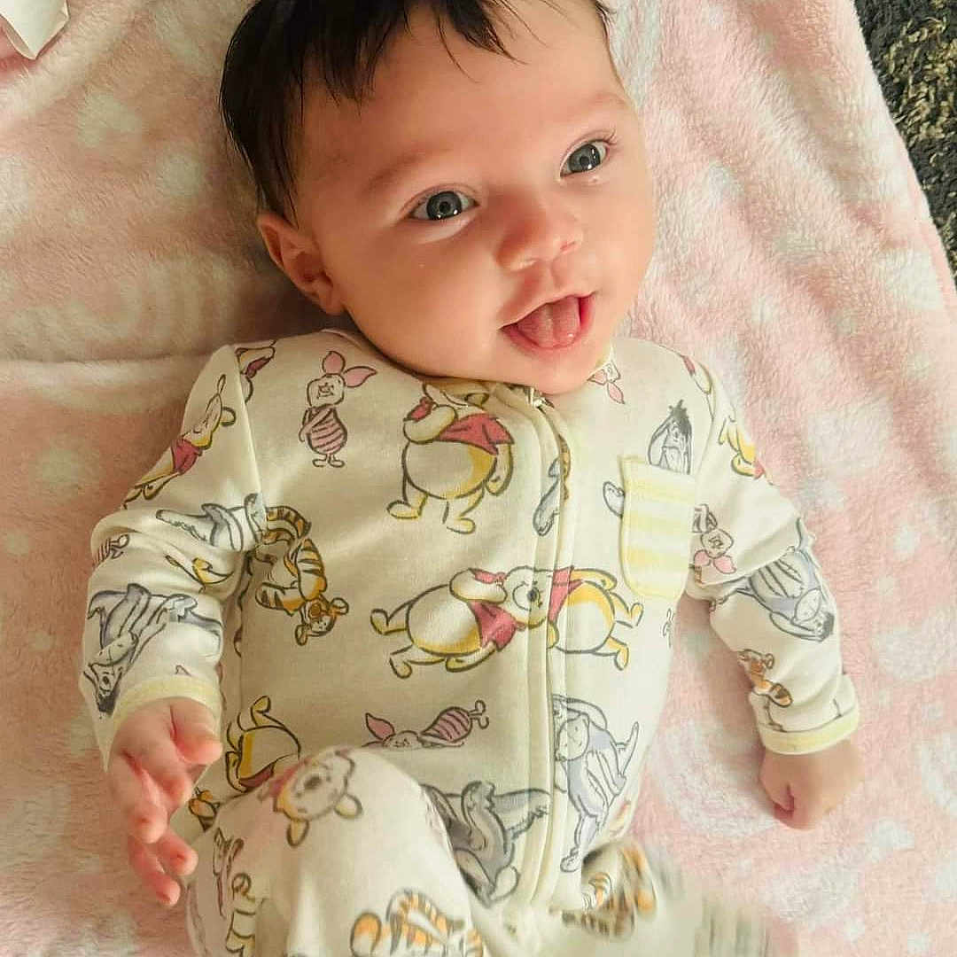 Aryanna is registered to the contest to win money with this photo: baby, babylaughing, blanket, clothing, face, happy, head, newborn, pajamas, person, photography, portrait, sleeve, smile, yawning