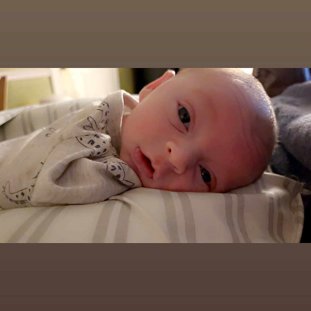 Keegyn is registered to the contest to win money with this photo: baby, bed, blanket, bodypart, bonnet, clothing, couch, cushion, face, finger, furniture, hand, hat, head, homedecor, newborn, person, photography, portrait, quilt